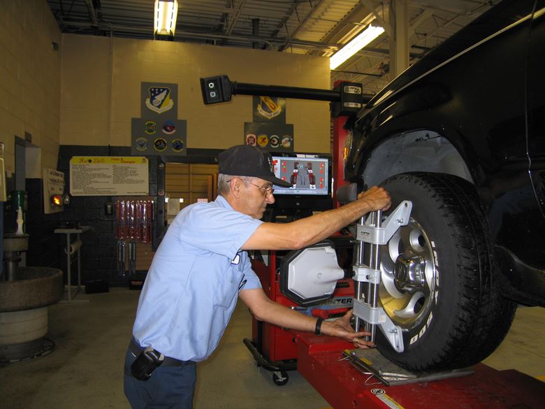 technician aligns wheel
